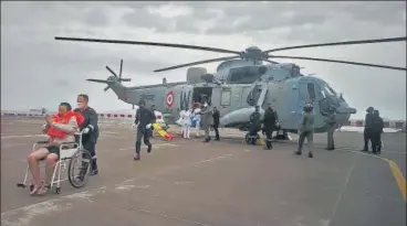  ?? VIA REUTERS ?? Indian Navy and Coast Guard rescue people from two barges that went adrift in the Arabian Sea before Cyclone Tauktae made landfall on the western coast, at the naval air station INS Shikra in Mumbai on Tuesday.
Full coverage on page 8