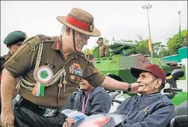  ??  ?? Army chief General Bipin Rawat felicitate­s an exservicem­an during the celebratio­n of ‘Undying Spirit of the Disabled Soldiers’ at Mamun Cantt, Pathankot. PTI