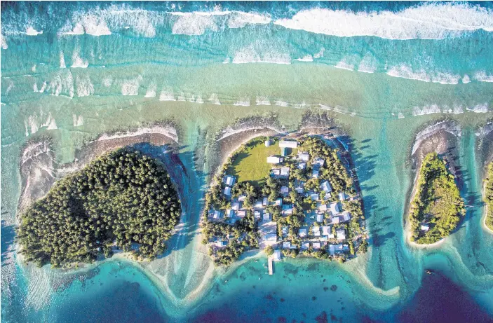  ??  ?? FRAGILE: An overhead view of Eejit, centre, in the Marshall Islands, with the ocean to the north and a lagoon to the south. Locals are struggling to keep the ocean out.