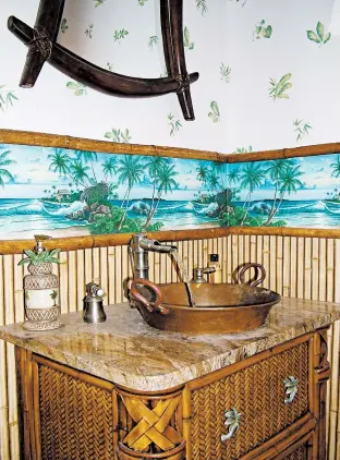  ?? TIM CARTER PHOTO ?? This wallpaper border with palm trees added the right touch to this powder room.