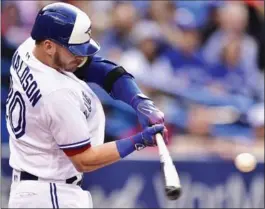  ?? FRANK GUNN, THE CANADIAN PRESS ?? Blue Jays third baseman Josh Donaldson hits a solo homer against the New York Yankees during first-inning action at Rogers Centre on Friday night. For the game report, go to thespec.com.