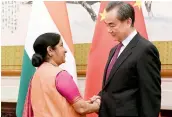  ?? — PTI ?? Foreign minister Sushma Swaraj with her Chinese counterpar­t Wang Yi prior in Beijing on Sunday.