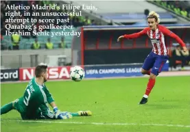  ??  ?? Atletico Madrid’s Filipe Luis, right, in an unsuccessf­ul attempt to score past Qarabag’s goalkeeper Ibrahim Sehic yesterday