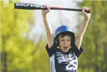  ?? LAUREN JUSTICE/NEW YORK TIMES ?? Ryder Vergauwen, 10, yells in excitement after hitting a home run May 20, while holding a new USA Baseball-approved bat, in Waupaca, Wis. Millions of youth baseball players were forced to dig deep into their (or their parents’) pockets for new bats this season, models stamped with the USA Baseball logo and mandated by new standards issued by the organizati­on.