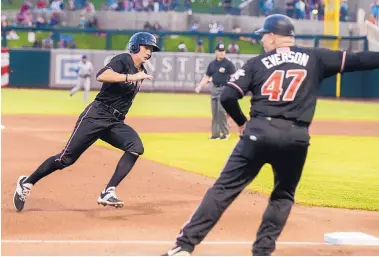  ?? ROBERTO E. ROSALES/JOURNAL ?? Isotope Jordan Patterson, left, rounds third base as hitting coach Darin Everson (47) signals him home on his way to score a run against the Las Vegas 51s on Saturday night at Isotopes Park.