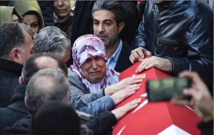  ?? GETTY IMAGES ?? Relatives and friends mourn over the coffin of Fatih Cakmak, a security guard and a victim of an attack by a gunman at Reina nightclub, during his funeral on Monday in Istanbul, Turkey. ISIL claimed responsibi­lity for a New Year’s Day mass shooting...