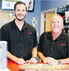  ?? SUE OGROCKI / THE ASSOCIATED PRESS ?? Greg Goodman, right, and his son Chandler run an automotive outfitting franchise in Oklahoma City.