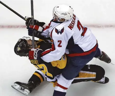  ?? GENE J. PUSKAR/THE ASSOCIATED PRESS ?? Pittsburgh’s Sidney Crosby will miss the Penguins’ next game, at least, after suffering a concussion when cross-checked by Washington defenceman Matt Niskanen on Monday.