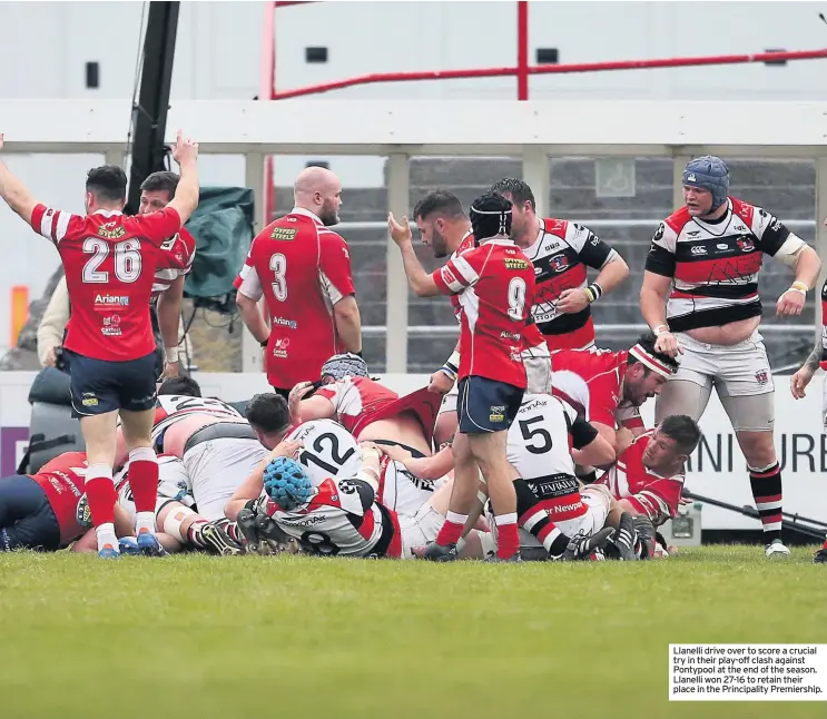  ??  ?? Llanelli drive over to score a crucial try in their play-off clash against Pontypool at the end of the season. Llanelli won 27-16 to retain their place in the Principali­ty Premiershi­p.