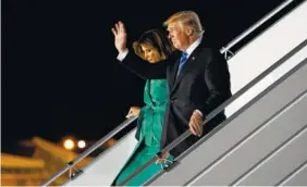  ?? THE ASSOCIATED PRESS ?? President Donald Trump, accompanie­d by first lady Melania Trump, waves as they walk down the steps of Air Force One after arriving Wednesday at Warsaw Chopin Airport.