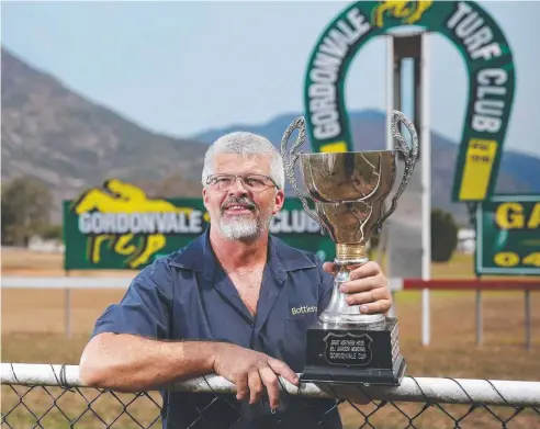  ??  ?? SPECIAL HONOUR: Brett Dawson with the Bill Dawson Memorial Gordonvale Cup, in memory of his father. Picture: BRENDAN RADKE