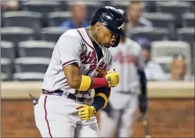  ?? THE ASSOCIATED PRESS ?? Braves’ Ronald Acuña Jr. reacts while crossing the plate after hitting a solo home run during the fifth inning against the Mets, Monday.