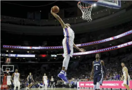  ?? MATT SLOCUM — THE ASSOCIATED PRESS ?? Sixers rookie Markelle Fultz goes flying in for a right-hand slam during the second half of a preseason game against the Memphis Grizzlies Wednesday night. Fultz did not practice Thursday and missed Friday’s preseason game against Boston with right...