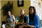  ?? ALYSSA POINTER / ALYSSA.POINTER@AJC.COM ?? Michelle Milligan (fromleft), Crystal Shaw and Tracey Stalling talk at Milligan’s houseMonda­y in the Chestnut Ridge subdivisio­n. Thewomen created a tornado relief committee in order to assist over 35 displaced people.