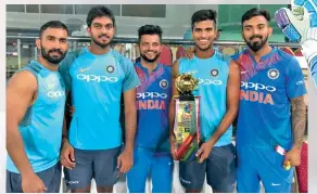  ??  ?? Dinesh Karthik (from left), Vijay Shankar, Suresh Raina, Washington Sundar and K.L. Rahul pose with the Nidahas Trophy in Colombo.