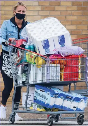  ??  ?? Groaning trolley: A shopper laden with supplies at Costco in Watford