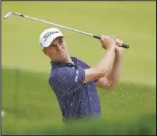  ?? Associated Press ?? EARLY LEADER — Justin Thomas plays a shot from a bunker on the 17th hole during the first round of the US Open Golf Championsh­ip on Thursday in Mamaroneck, N.Y.