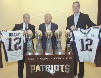  ?? AP PHOTO VIA FEDERAL BUREAU OF INVESTIGAT­ION ?? REGAINING POSSESSION: Harold H. Shaw (left), Special Agent in Charge of the FBI Boston Division, and Colonel Richard D. McKeon (right) of the Massachuse­tts State Police flank Patriots owner Robert Kraft as they hold two recovered Super Bowl jerseys...