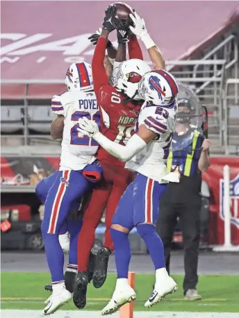  ?? GETTY IMAGES ?? Cardinals wide receiver DeAndre Hopkins hauls in a pass in the waning seconds amid a trio of Bills defenders for a winning touchdown Sunday.