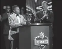  ?? JULIO CORTEZ, THE ASSOCIATED PRESS ?? T.J. Owuanibe, 14, announces the Baltimore Ravens’ selection during the first round of the 2017 NFL football draft, Thursday.