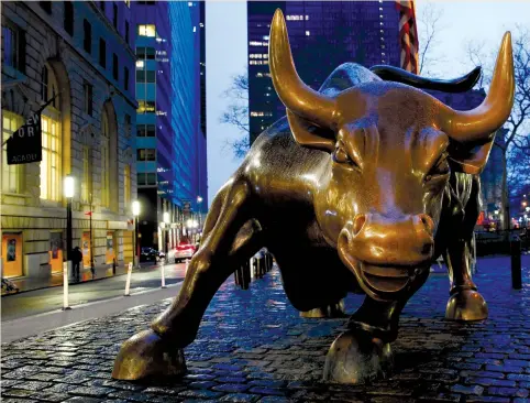  ?? (Brendan McDermid/Reuters) ?? THE WALL STREET bull is seen in New York’s financial district earlier this year. Global wealth rose almost $17 trillion in the past year to $280t., Credit Suisse’s annual report said last week. Much of the new wealth is trickling into investment...