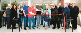  ?? BOB BONG/DAILY SOUTHTOWN ?? Pizza Castle co-owner Rich Jensen cuts the ribbon Nov. 17 at the restaurant’s new location in Hickory Hills.