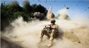  ?? (Shamil Zhumatov/Reuters) ?? A US SOLDIER takes cover during a controlled detonation in southern Afghanista­n’s Kandahar Province in 2012.