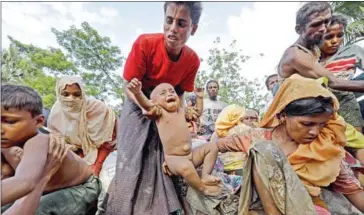  ?? KM ASAD/AFP ?? Rohingya Muslim refugees from Myanmar arrive at a new camp in Unchiprang near the Bangladesh­i border town of Teknaf on September 5.