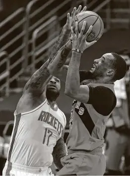  ?? Chris O'Meara / Associated Press ?? Raptors guard Norman Powell shoots over Rockets forward P.J. Tucker during the first half. Powell led the Raptors with 30 points on 10-of-15 shooting.