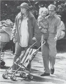  ??  ?? Mia Farrow, left, and Woody Allen with Dylan, about age 2, in his arms.
