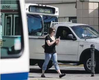  ?? DARREN STONE, TIMES COLONIST ?? Pedestrian­s should get off their cellphones when crossing streets, a reader suggests, noting that drivers should not bear responsibi­lity for distracted walkers.