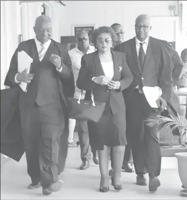  ??  ?? Chairperso­n of the Guyana Elections Commission (GECOM) Justice (ret’d) Claudette Singh (centre) and Senior Counsel Neil Boston (at left) making their way out of the court room to attend a meeting yesterday morning.