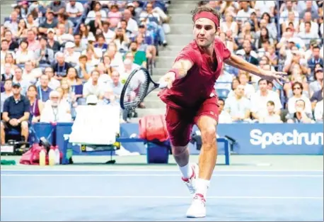  ?? AFP ?? Roger Federer returns the ball to John Millman during their 2018 US Open men’s singles match at the USTA Billie Jean King National Tennis Center in New York on Monday.