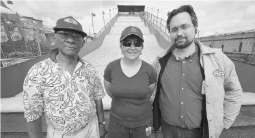  ?? JOHN LUCAS, EDMONTON JOURNAL ?? Volunteers, from left, Winston Edwards, Krista and Robert Leddy work at the Kiwanis Giant Slide at the Capital Ex grounds on Saturday. The ride is the Edmonton Kiwanis Club’s main fundraiser.