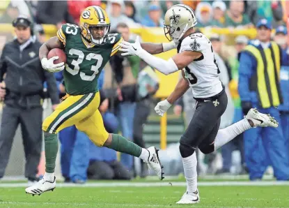  ?? DAN POWERS / USA TODAY NETWORK-WISCONSIN ?? Green Bay Packers running back Aaron Jones fends off New Orleans Saints cornerback Marshon Lattimore in the second half. Jones rushed for 131 yards against the Saints.