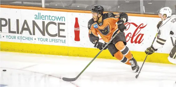  ?? APRIL GAMIZ ?? The Phantoms’ Zayde Wisdom (14) tries to control the puck against Hershey’s Cameron Schilling at Allentown’s PPL Center on Wednesday.