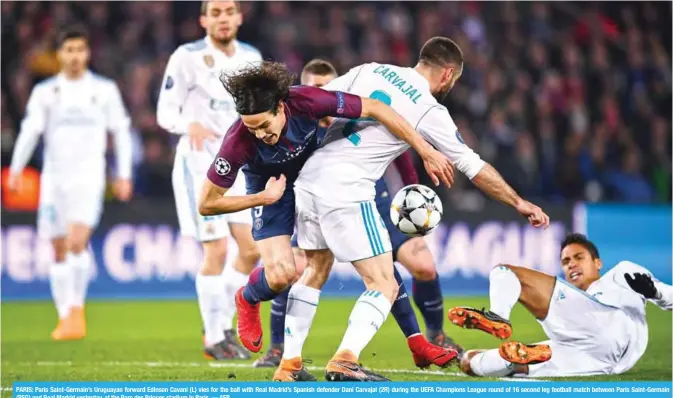  ??  ?? PARIS: Paris Saint-Germain’s Uruguayan forward Edinson Cavani (L) vies for the ball with Real Madrid’s Spanish defender Dani Carvajal (2R) during the UEFA Champions League round of 16 second leg football match between Paris Saint-Germain (PSG) and Real...