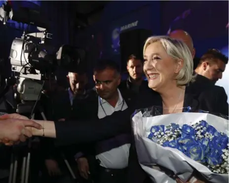  ?? FRANK AUGSTEIN/THE ASSOCIATED PRESS ?? Far-right leader Marine Le Pen celebrates with supporters after frist-round exit polls Sunday showed her in a runoff with centrist Emmanuel Macron.