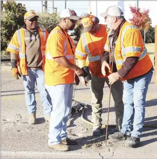  ?? Katie West • Times-Herald ?? An Arkansas Department of Transporta­tion crew investigat­es an area on Highway 1 near the Highway 70 intersecti­on. The ArDOT crew used equipment to make a hole in the indentatio­n and a rod to check for any clues as to why the highway has a depression in that area. ArDOT is planning to resurface Highway 70 through St. Francis County.