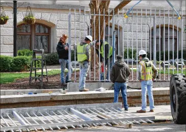  ??  ?? Workers install spiked metal fencing outside the Georgia Capitol on Tuesday. “It has a medieval quality to it with the spikes,” Democratic state Sen. Sally Harrell says. “What bothers me is that this is the People’s House and it looks like they’re trying to keep people away.”