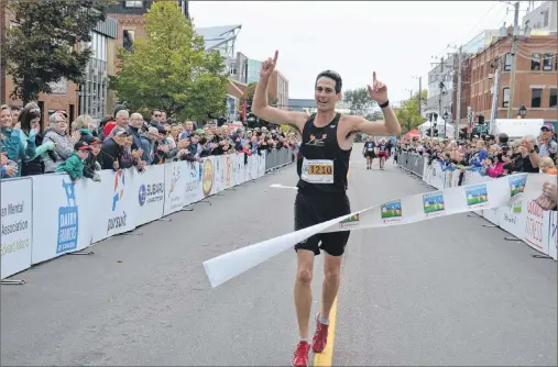  ?? KATIE SMITH/THE GUARDIAN ?? Stan Chaisson, winner of the full marathon, makes his way across the finish line in downtown Charlottet­own after he completed his race in the 14th annual P.E.I. Marathon on Sunday.