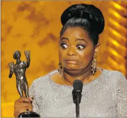  ??  ?? ROBERT GAUTHIER/LOS Angeles Times/mct Octavia Spencer accepts her award at the 18th annual Screen Actors Guild
Awards show at the Shrine Auditorium in Los Angeles.