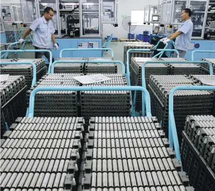  ?? CHINATOPIX VIA AP ?? Workers transfer lithium-ion batteries in a factory in Taizhou in east China’s Jiangsu province last month. China’s shipments to the U.S. rose 13 per cent in July from a year earlier, to US$41.5 billion, as the U.S.’s extra 25-per-cent tariffs on Chinese imports are set to start Aug. 23.