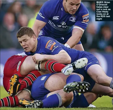  ??  ?? BUSY: Brian O’Driscoll helps clear out a ruck as Cian Healy looks on at the RDS last night