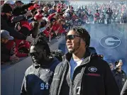  ?? HYOSUB SHIN/AJC 2023 ?? Georgia offensive lineman Devin Willock (right) enters Sanford Stadium in Athens for the Jan. 14 celebratio­n of the Bulldogs’ 2022 National Championsh­ip. Hours later, he was killed in a crash.