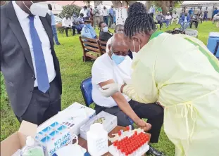  ??  ?? DONE:
Frontline workers being vaccinated