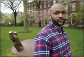  ?? STEVEN SENNE — THE ASSOCIATED PRESS ?? Brown University graduate Jason Carroll, a Maryland native whose ancestors were slaves in the Carolinas, stands on the Brown campus in Providence, R.I., on Tuesday near the Slavery Memorial, left, by sculptor Martin Puryear.