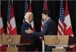  ?? SEAN KILPATRICK — THE CANADIAN PRESS VIA AP ?? U.S. President Joe Biden and Canada's Prime Minister Justin Trudeau embrace following a joint news conference in Ottawa, Ontario, on Friday.