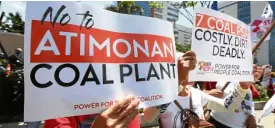  ?? NIÑO JESUS ORBETA ?? FIGHTING COAL Residents of Atimonan town, Quezon, and members of the group Power for People rally on Ortigas Avenue on June 5 to protest the continued constructi­on of another coal power plant in Quezon province.—