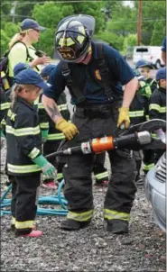  ?? MARIAN DENNIS – DIGITAL FIRST MEDIA ?? Campers were shown the ropes during events at youth fire fighting camp in Limerick. Kids got to learn about the tools used at the scene of an accident as well as how to transport a victim.